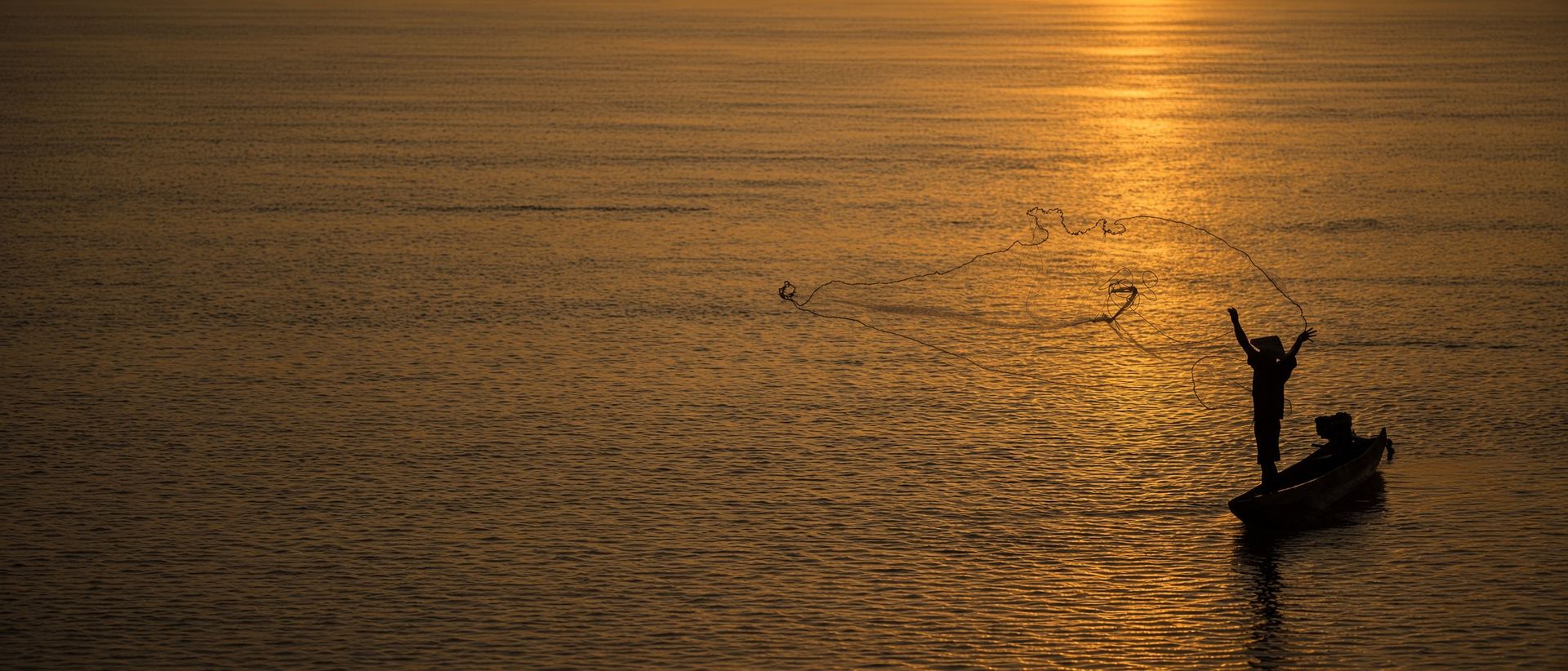 Sunrise and a fisherman on the Mekong River