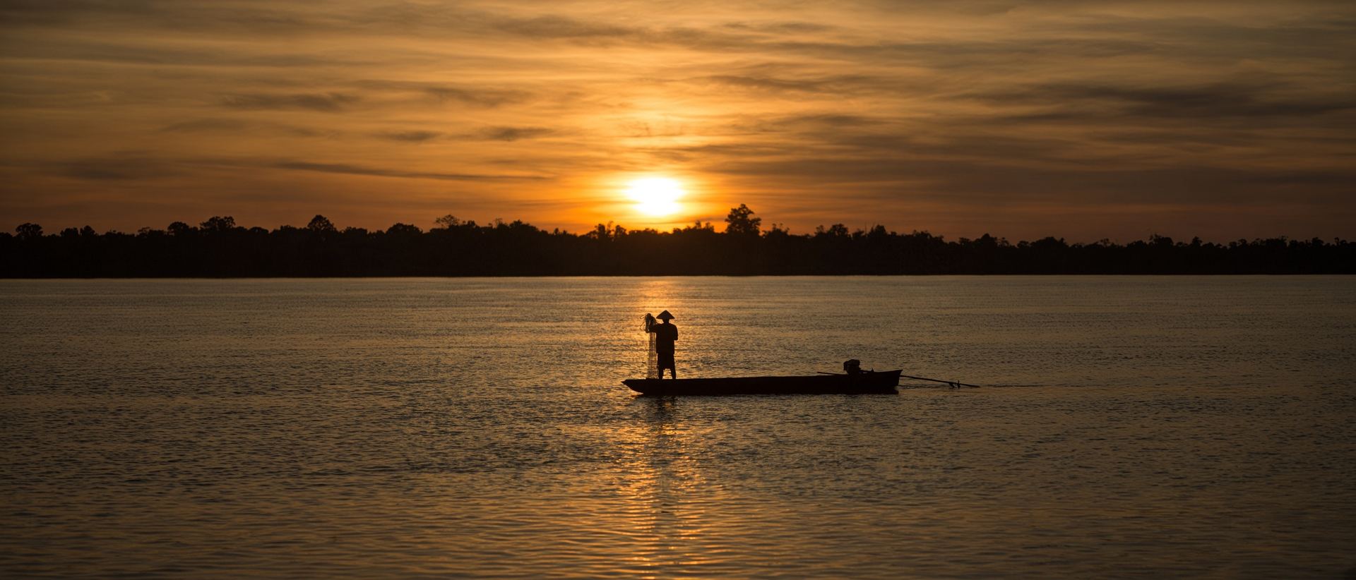 Fishermen at sunrise on the Mekong River